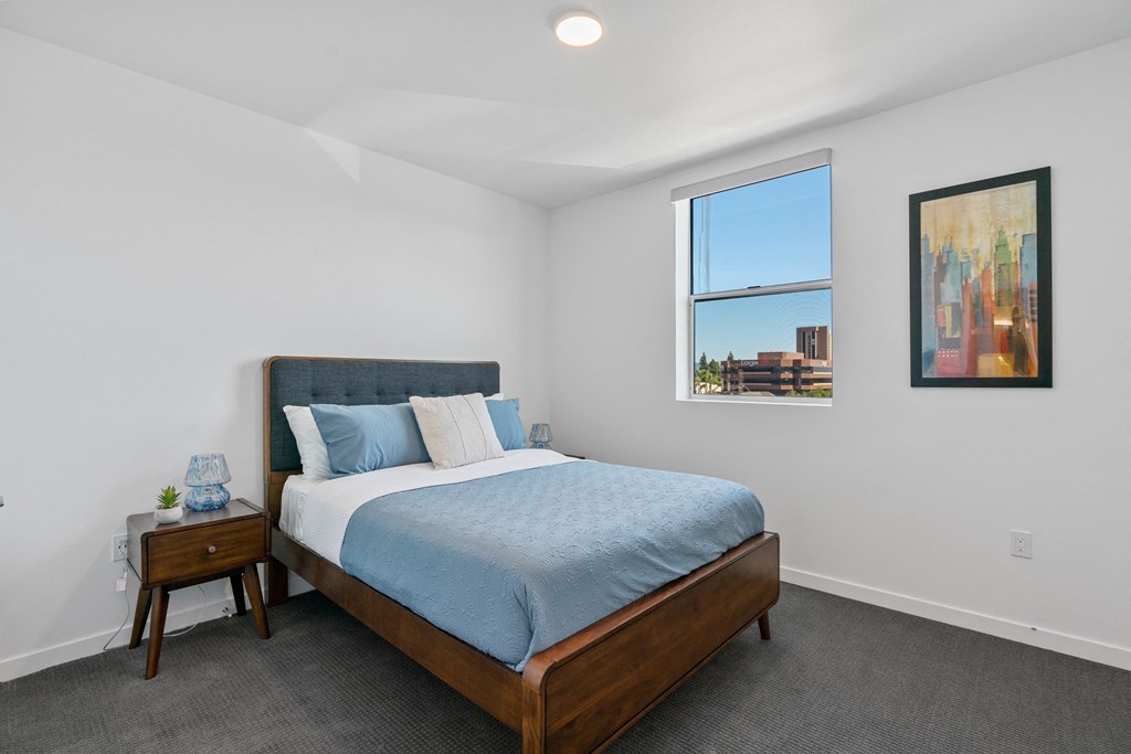 a bedroom with a large bed and a window