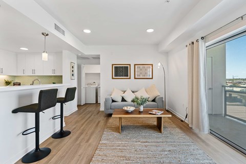 A modern living room with a grey sofa and a coffee table.
