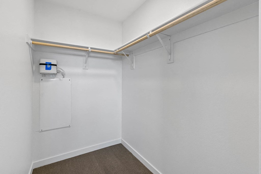 room with white walls and a white dryer in the corner