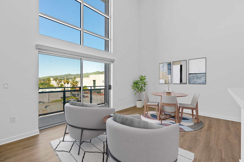 a living room with couches and a table and a large window
