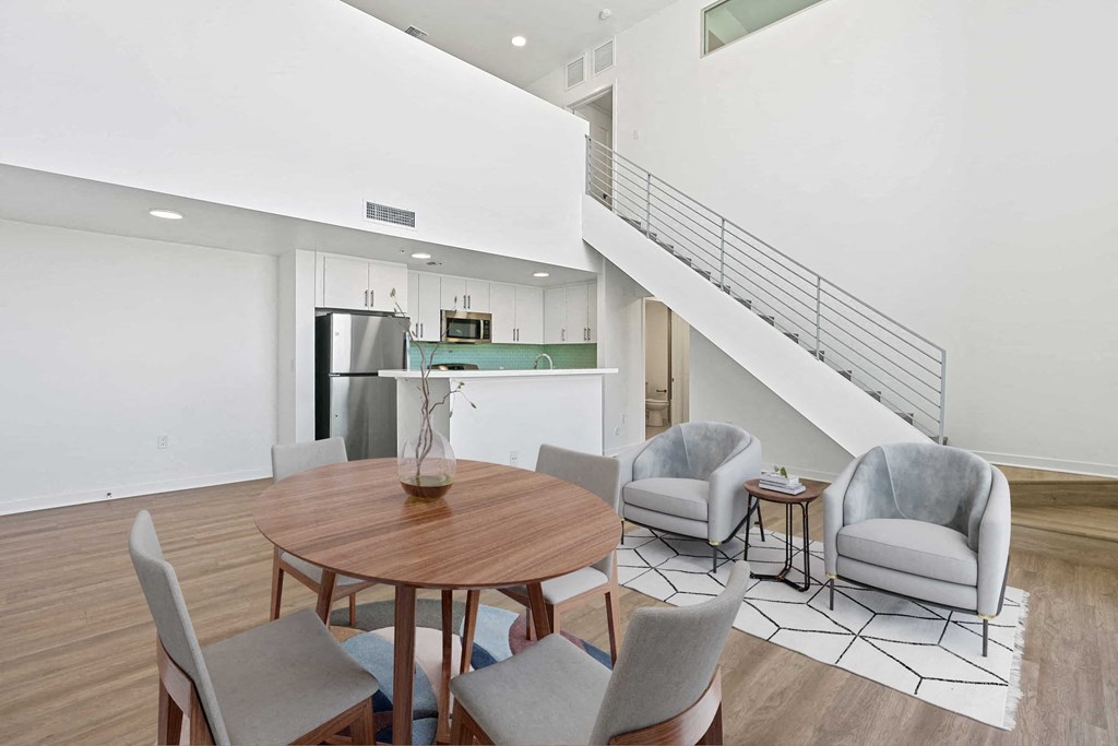 a dining room with a table and chairs and a kitchen