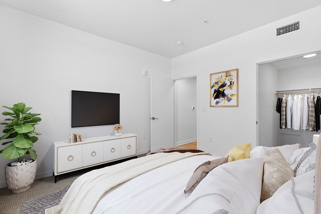 a bedroom with a large bed and a tv