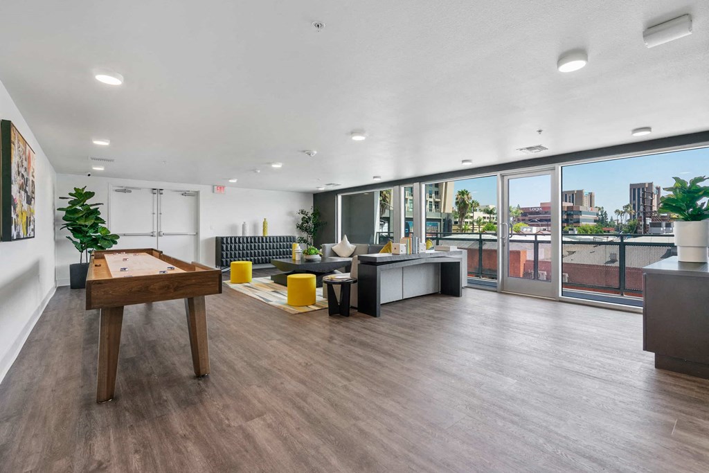 an open living room with a pool table and a balcony