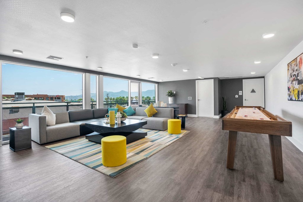 a living room with couches and a pool table