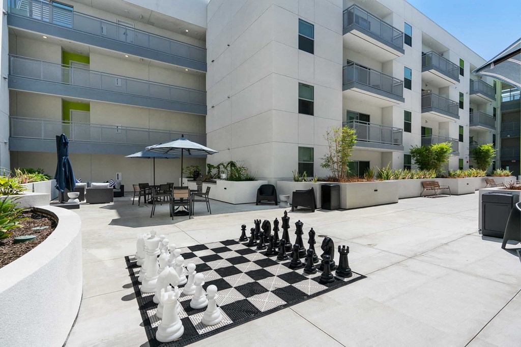 a chess board in front of an apartment building