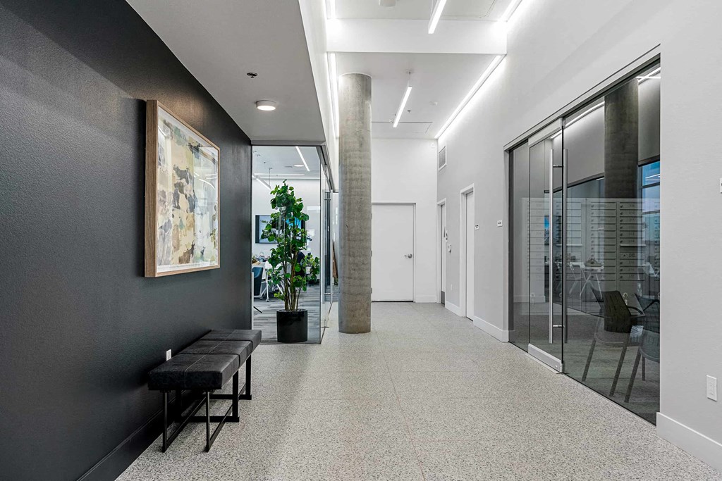 a large hallway with glass doors and a potted plant