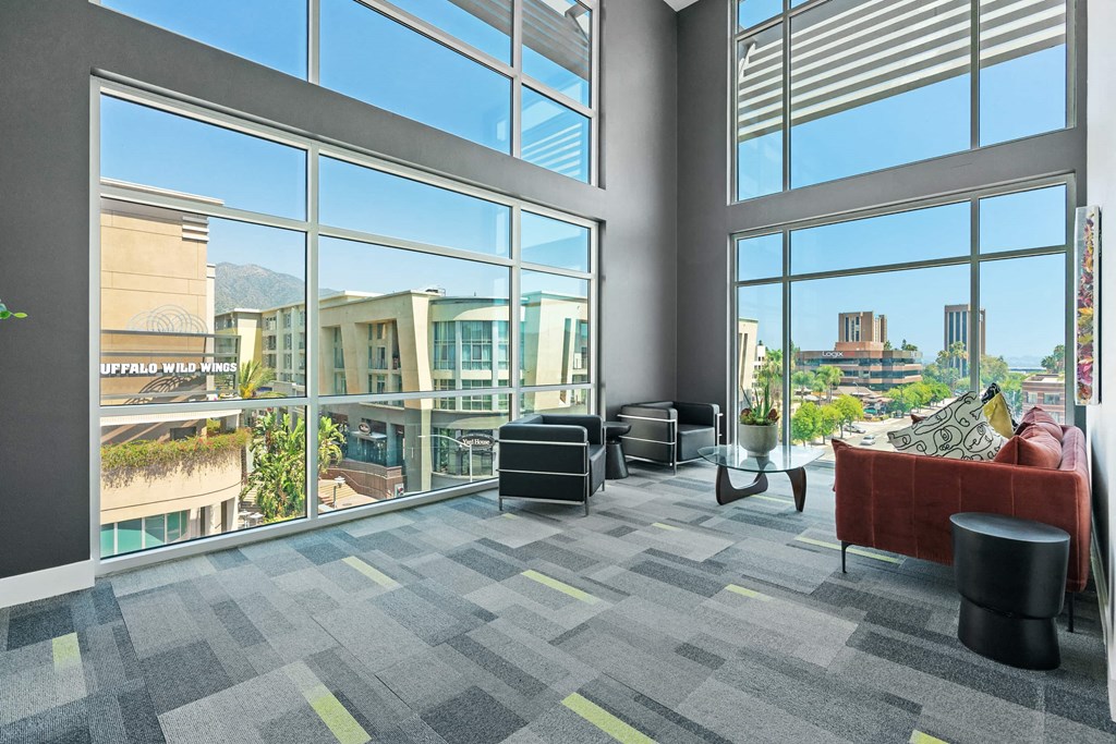 a living room with large windows and a city view