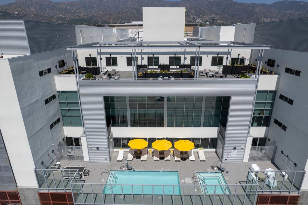 a view of the top of a building with yellow umbrellas
