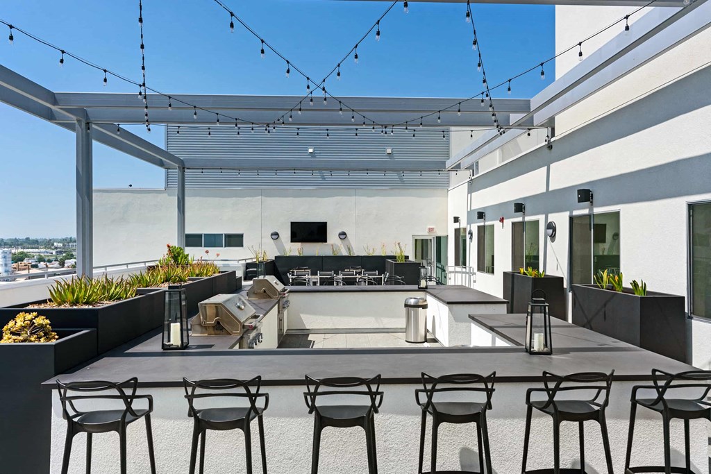 a large patio with chairs and tables and a pool