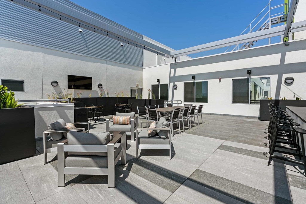 a patio with tables and chairs and a bar