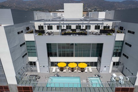 A large white building with a pool in front.