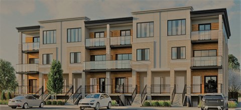 A modern apartment building with cars parked in front.