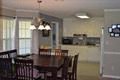 a dining room with a wooden table and chairs
