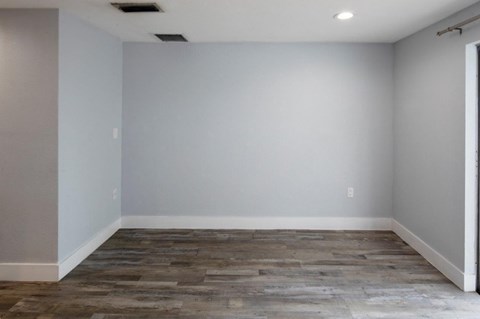A room with a grey floor and white walls.