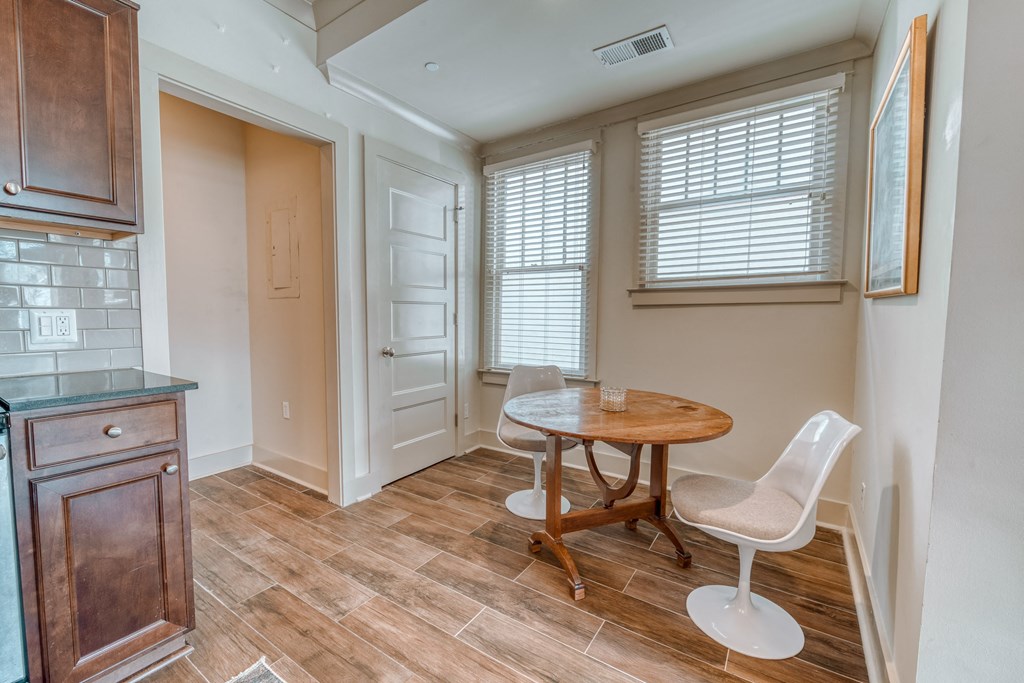 a dining room with a table and chairs and a kitchen