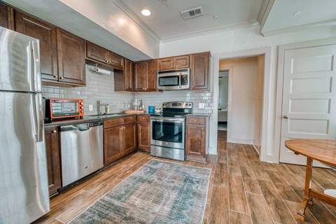 a kitchen with stainless steel appliances and wooden cabinets