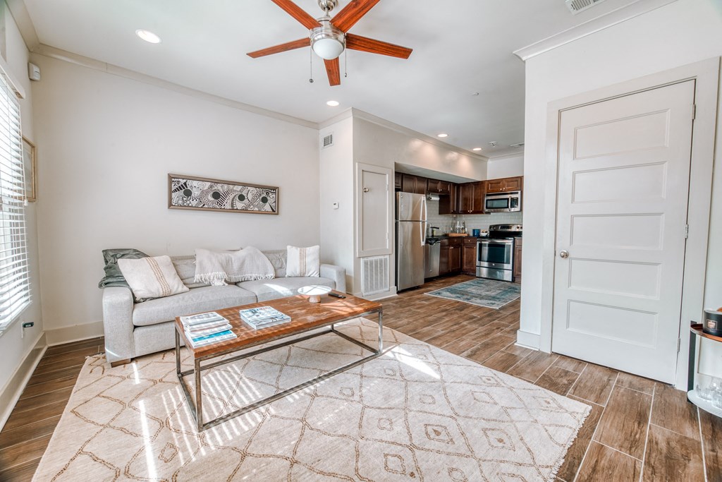 a living room with a couch and a ceiling fan
