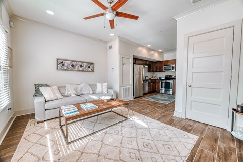 a living room with a couch and a ceiling fan