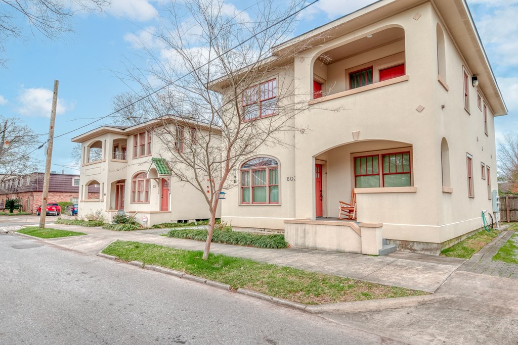 a house with a sidewalk and a street in front of it
