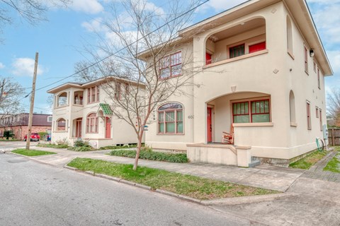 a house with a sidewalk and a street in front of it