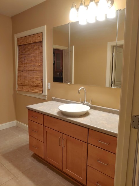A bathroom with a sink and a mirror.