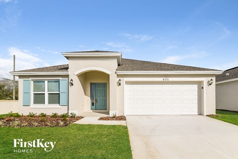 A house with a blue door and a garage door.