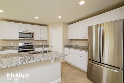 a kitchen with granite counter tops and stainless steel appliances