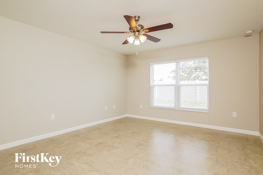a living room with a ceiling fan and a window