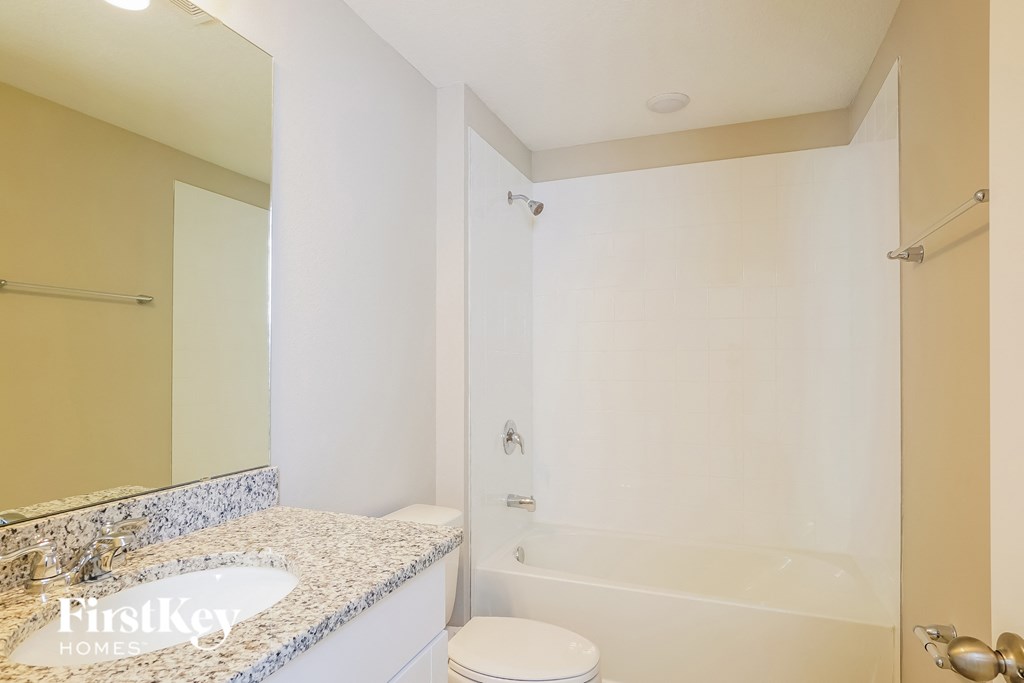 a bathroom with a shower and a sink and a toilet