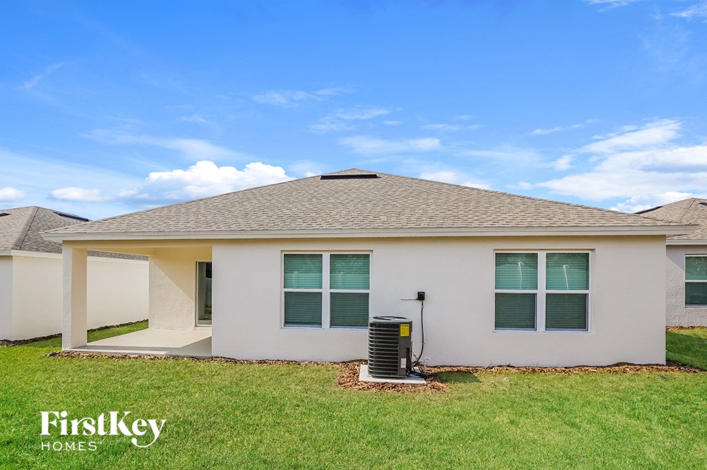 a home with an air conditioner in the front yard