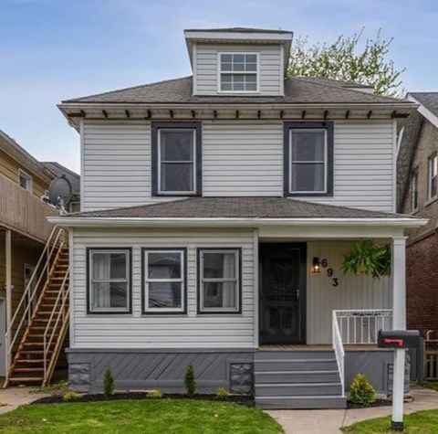 a white house with a roof on top of it