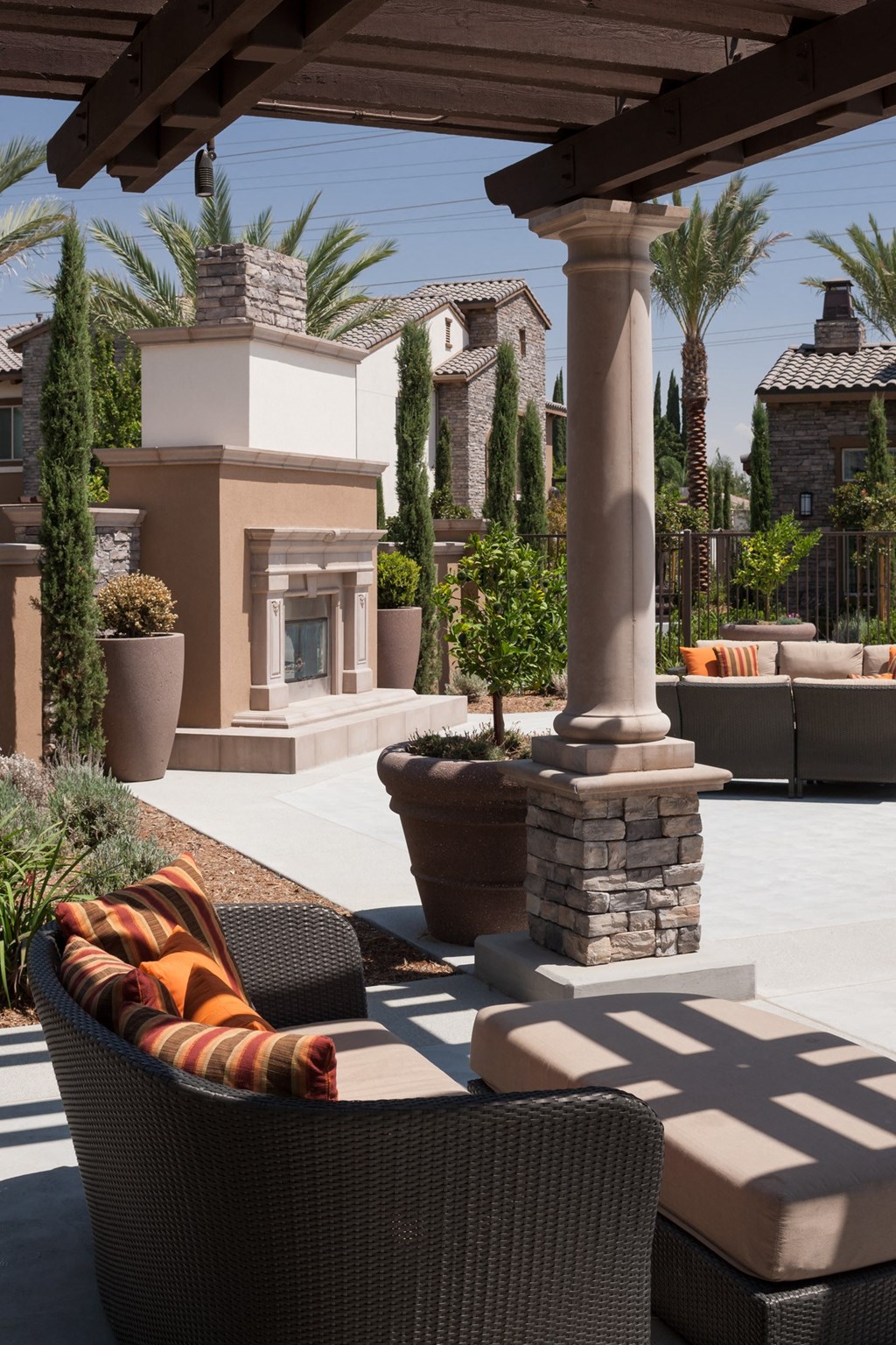 an outdoor patio with chairs and a fireplace