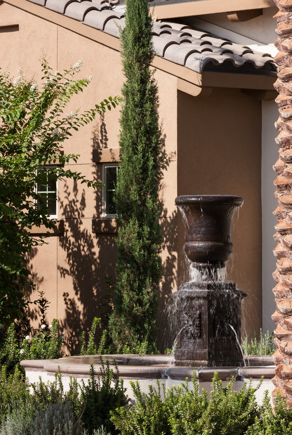 a fountain in a courtyard in front of a building