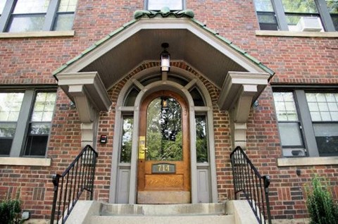 the front of a brick building with a door