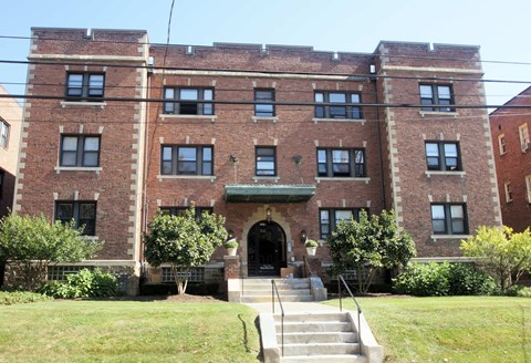 a large brick building with stairs in front of it