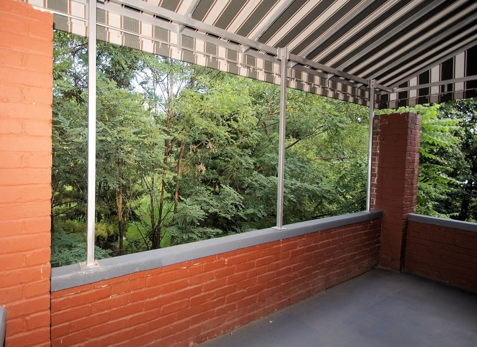 a balcony with a view of the trees