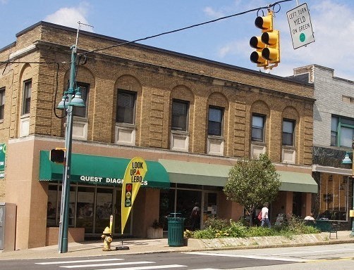 a building on the corner of a street with a traffic light