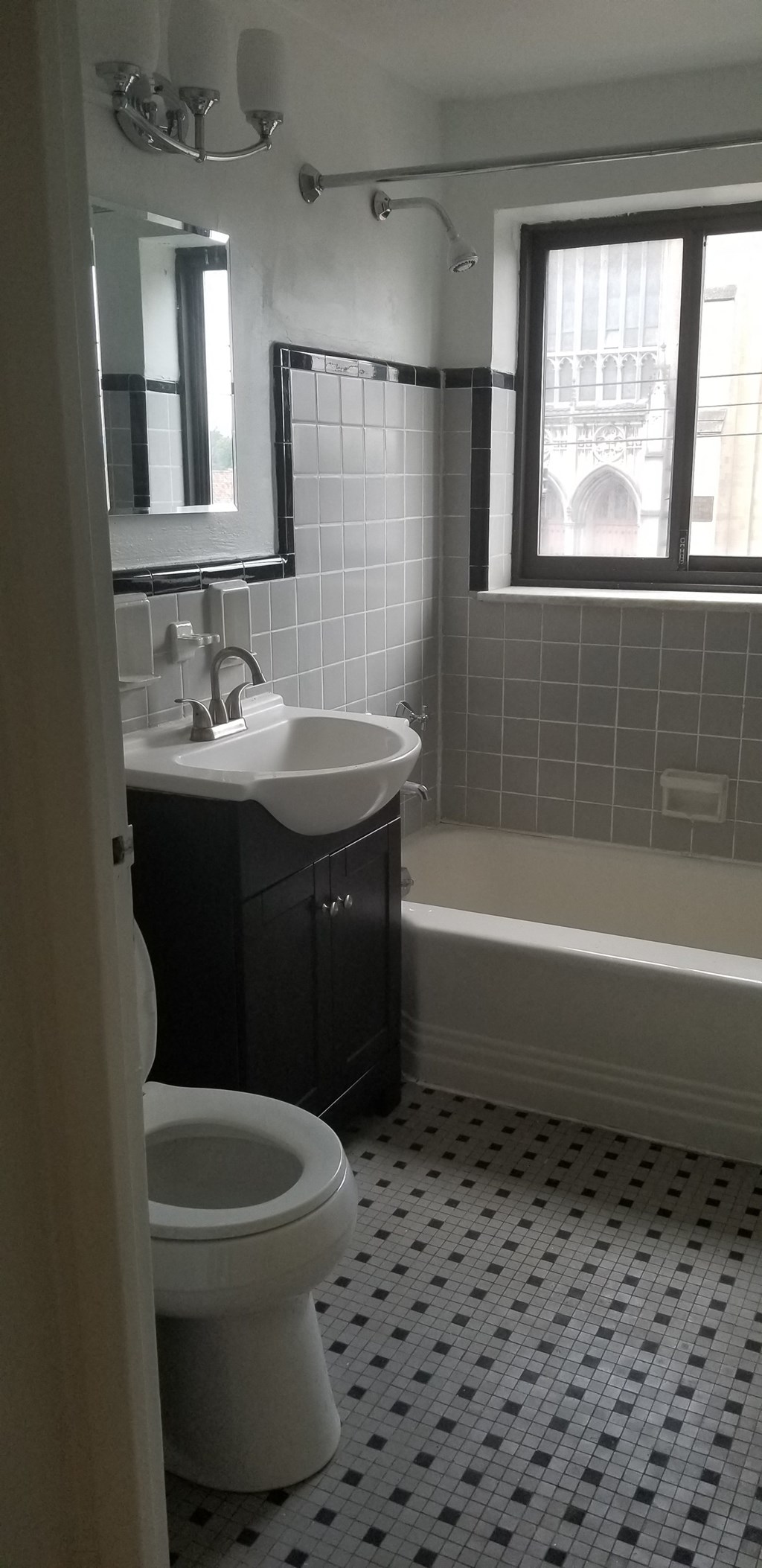 a bathroom with a toilet and a sink and a bath tub