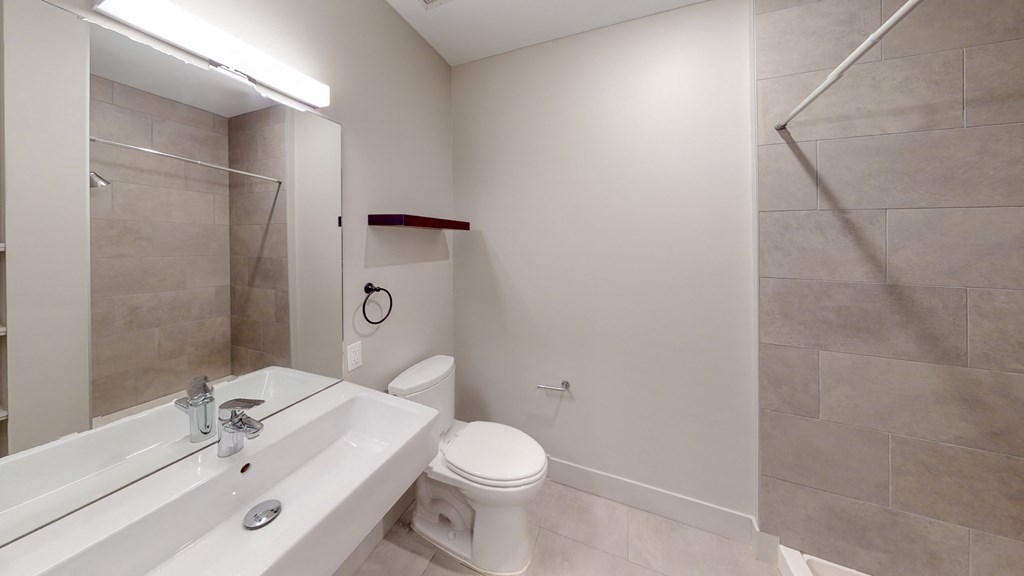 a bathroom with a toilet and a sink and a shower