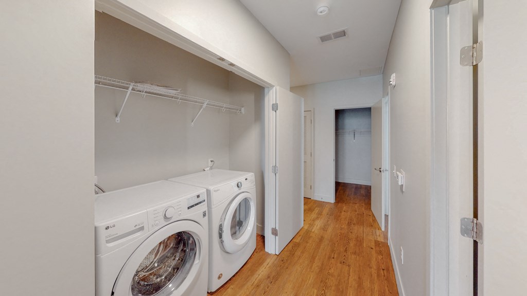 a laundry room with a washer and dryer and a closet