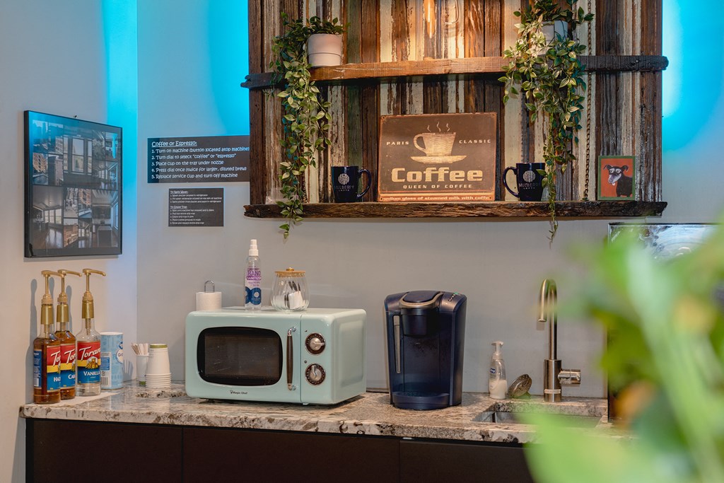 a counter with a microwave and a coffee maker on it