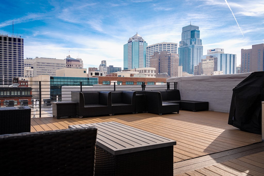 a rooftop deck with a view of the city