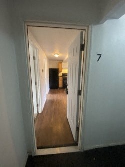 A hallway with a doorway leading to another room.