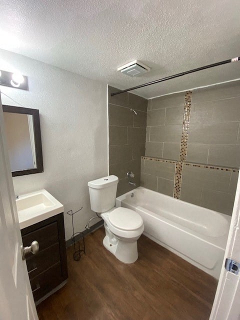 A white toilet sits in a bathroom next to a white sink and a white bathtub.