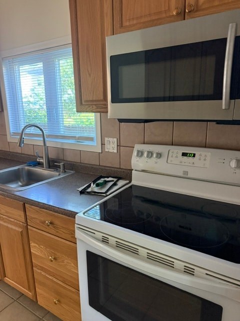 A white oven and microwave in a kitchen.