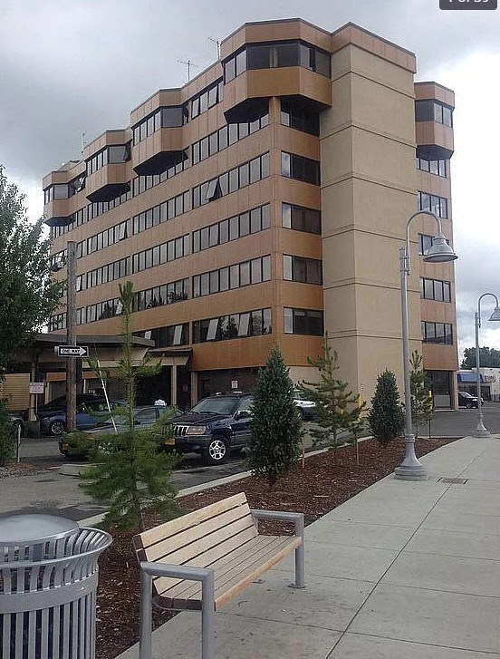 A large beige building with a lot of windows and balconies.
