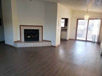 A living room with a fireplace and sliding glass doors.