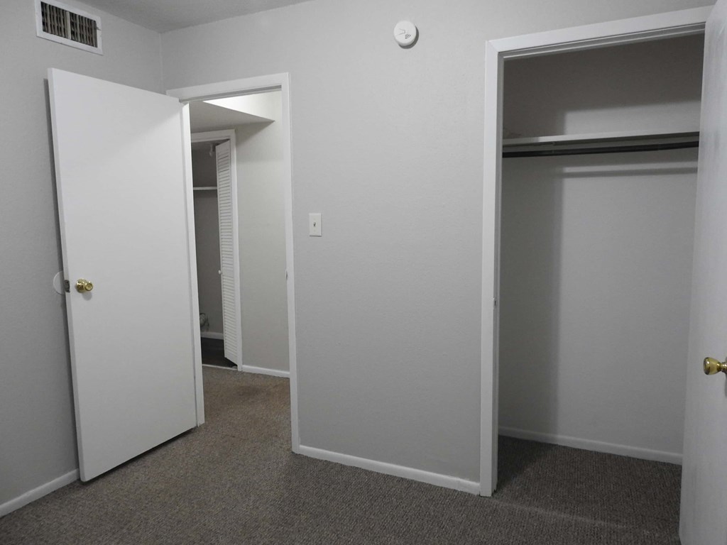 A white door is open to a hallway.