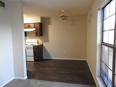 A room with a ceiling fan and a window.