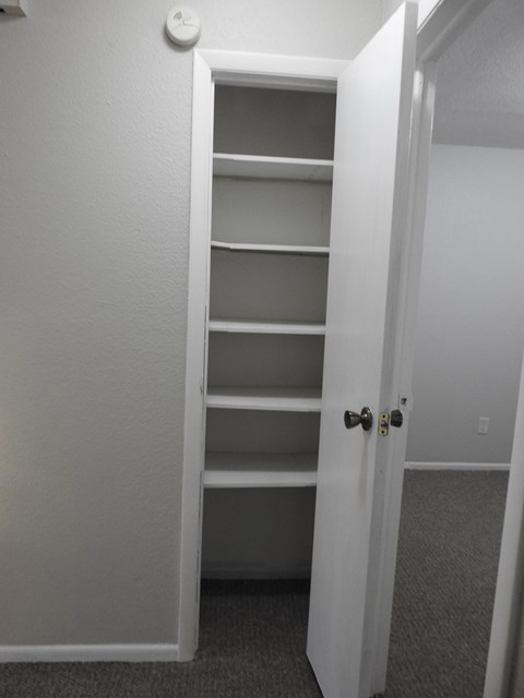 A white door with a black handle is open.